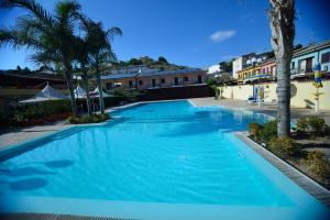 a large swimming pool with blue water at Case Vacanze Ancora in Porto Empedocle