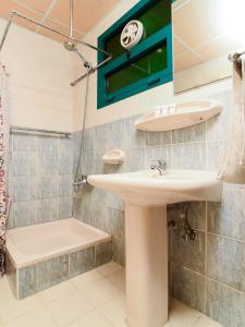 a bathroom with a sink and a shower at Sama Hotel in Sharjah