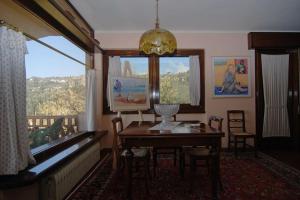 a dining room with a table and a window at Conca di Sopra in Massarosa