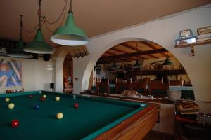 a pool table in a living room with at Conca di Sopra in Massarosa