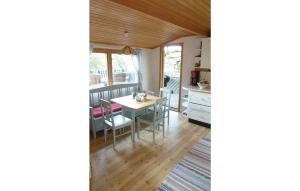 a kitchen and dining room with a table and chairs at Beautiful home in Frgelanda with 4 Bedrooms and WiFi in Färgelanda