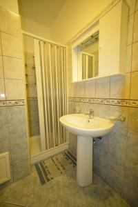 a bathroom with a sink and a mirror and a shower at Case Vacanze Ancora in Porto Empedocle