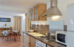 a kitchen with a sink and a stove top oven at Nice Apartment In La Valette Du Var With Wifi, Private Swimming Pool And Outdoor Swimming Pool in La Valette-du-Var