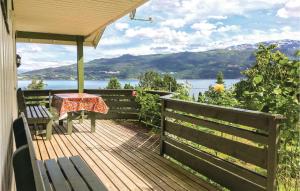 a wooden deck with a table and bench on a house at Stunning Home In Balestrand With 2 Bedrooms in Tuve
