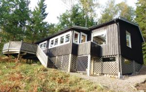 a tiny house sitting on top of a hill at Beautiful home in Frgelanda with 4 Bedrooms and WiFi in Färgelanda