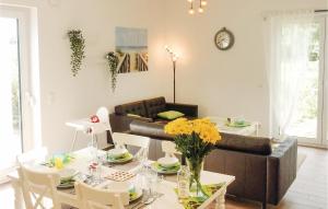 a living room with a table and a couch at Stunning Home In Boiensdorf With Sauna in Boiensdorf