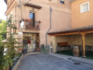 an outside view of a building with a patio at Hospedaje Rural Casa Parri in Poveda de la Sierra