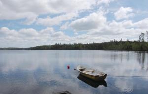 a boat sitting in the middle of a lake at Amazing Home In Osby With Wifi in Osby