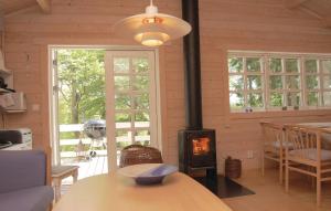 a living room with a wood stove in a house at 4 Bedroom Nice Home In Osby in Osby