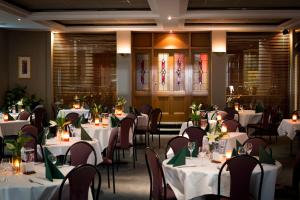 a dining room with white tables and chairs at Barkly Motorlodge in Ballarat
