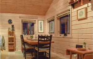 a wooden dining room with a table and chairs at 3 Bedroom Beautiful Home In seral in Åseral