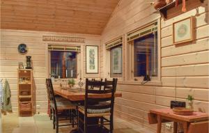 a wooden dining room with a table and chairs at Three-Bedroom Holiday Home In Aseral in Åseral +6 photos