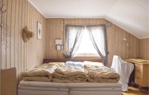 a bedroom with a large bed in front of a window at Awesome Home In Rauland With Wifi in Rauland