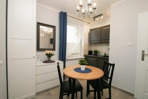 a kitchen with a table and chairs in a room at GOOD NIGHT | city Police (3km) | Szczecin | 2 pers in Szczecin