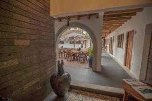 an archway leading to a dining room with a table at Villa San Juan Bed&Breakfast in Nuevo Vallarta 