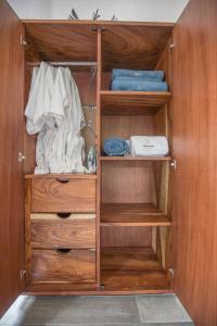 a closet with wooden walls and wooden shelves at Villa San Juan Bed&Breakfast in Nuevo Vallarta 