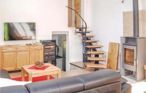 a living room with a couch and a fireplace at 2 Bedroom Gorgeous Home In Verchen in Verchen