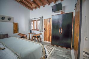 a bedroom with a bed and a sliding door at Villa San Juan Bed&Breakfast in Nuevo Vallarta 