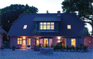 a brick house with lights on the front of it at Cozy Home In Gammelby With Sauna in Gammelby