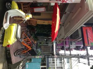 a view of a building with a motorcycle and a flag at Just Chill Inn in Chiang Mai