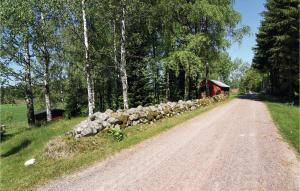 a herd of sheep on the side of a dirt road at Beautiful Home In Väse With Kitchen in Ve