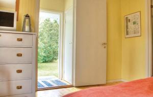 a bedroom with a door open to a yard at Stunning Home In Frjestaden With 2 Bedrooms And Wifi in Färjestaden