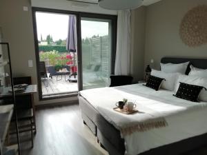a bedroom with a large bed and a balcony at Sweet Home studio Aix en Pce, clim,terrasse,piscine,pkg,resto in Aix-en-Provence