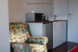 a living room with a chair and a microwave at ARCHITECT'S VIEW in Durban