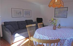 a living room with a table and a couch at Awesome Home In Lttorp With Kitchen in Löttorp
