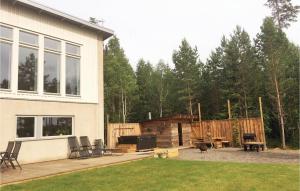 a backyard of a house with a patio and a grill at Lovely Home In Sandhem With Sauna in Sandhem