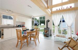 a kitchen and dining room with a table and a stove at Beautiful Home In Zerpenschleuse in Zerpenschleuse +19 photos