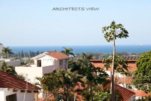 a view of the ocean from the roofs of houses at ARCHITECT'S VIEW in Durban