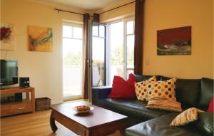 a living room with a couch and a coffee table at Amazing Apartment In Börgerende in Börgerende-Rethwisch +9 photos