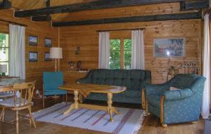 a living room with a couch and a table at Gorgeous Home In Lagan With Kitchen in Kvänarp +13 photos