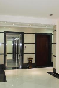 a lobby with two elevators in a building at Fakher Yanbu Hotel in Yanbu