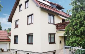 a white house with black windows at Nice Apartment In Nahetal-waldau With 1 Bedrooms And Wifi in Hinternah