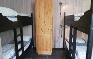 a room with two bunk beds and a door at Beautiful Apartment In Hemsedal With Sauna in Hemsedal