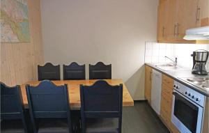 a small kitchen with a wooden table and chairs at Beautiful Apartment In Hemsedal With Sauna in Hemsedal