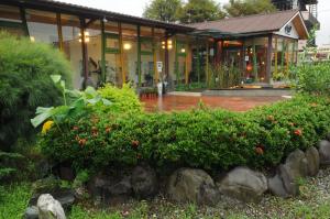 a house with a garden in front of it at Lotus Hostel Beicheng Zhuang in Luodong
