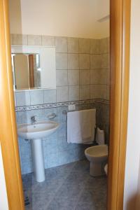 a bathroom with a sink and a toilet at Case Vacanze Ancora in Porto Empedocle