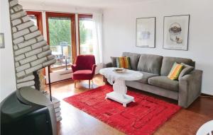 a living room with a couch and a table at Stunning Home In Landsbro With Kitchen in Landsbro