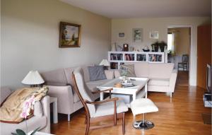 a living room with a couch and a table at Cozy Apartment In Hyltebruk With Wifi in Hyltebruk