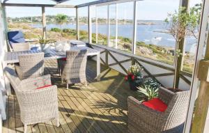 a balcony with a table and chairs and a view of the ocean at Villa Adens in Åsa