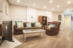a living room with a couch and a table at San Mames View Apartment in Bilbao
