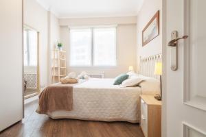 a bedroom with a bed and a window at San Mames View Apartment in Bilbao