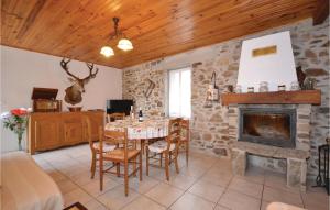 a living room with a table and a fireplace at Awesome Apartment In Les Salles Du Gardon With 2 Bedrooms And Wifi in Branoux-les-Taillades