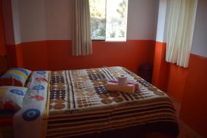 a bedroom with a bed with a quilt on it at Caroline lodging in Huaraz