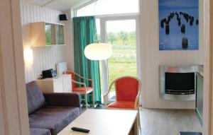 a living room with a couch and a tv at Friedrichskoog-Deichblick 10 in Friedrichskoog