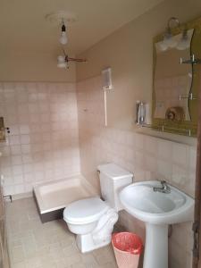 a bathroom with a white toilet and a sink at Hostel Buen descanso in Sucre +47 photos