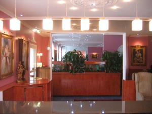 a salon with a waiting room with plants in it at Hotel ATLANTA in Darmstadt